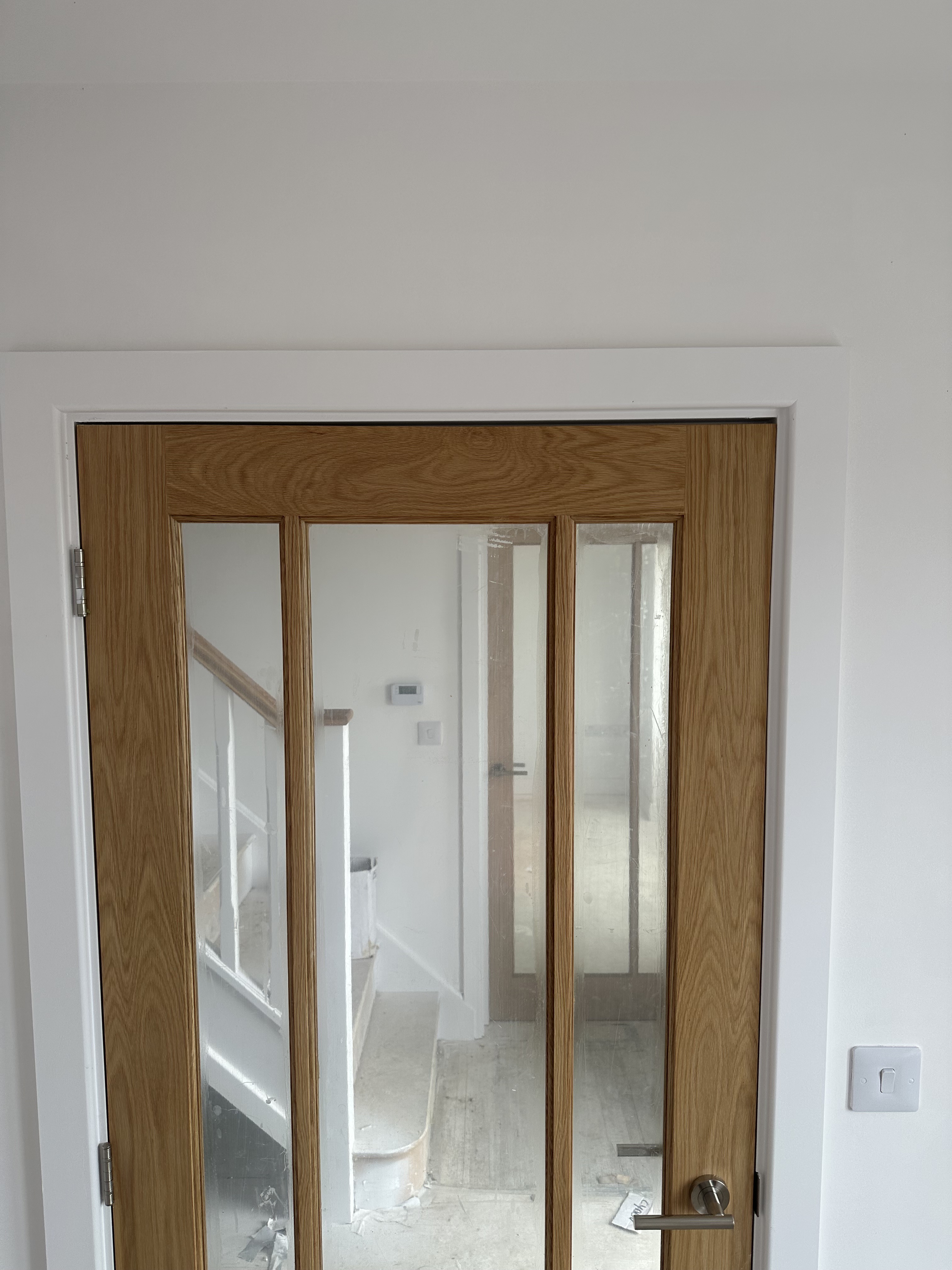 Oak glazed internal door hung and fitted