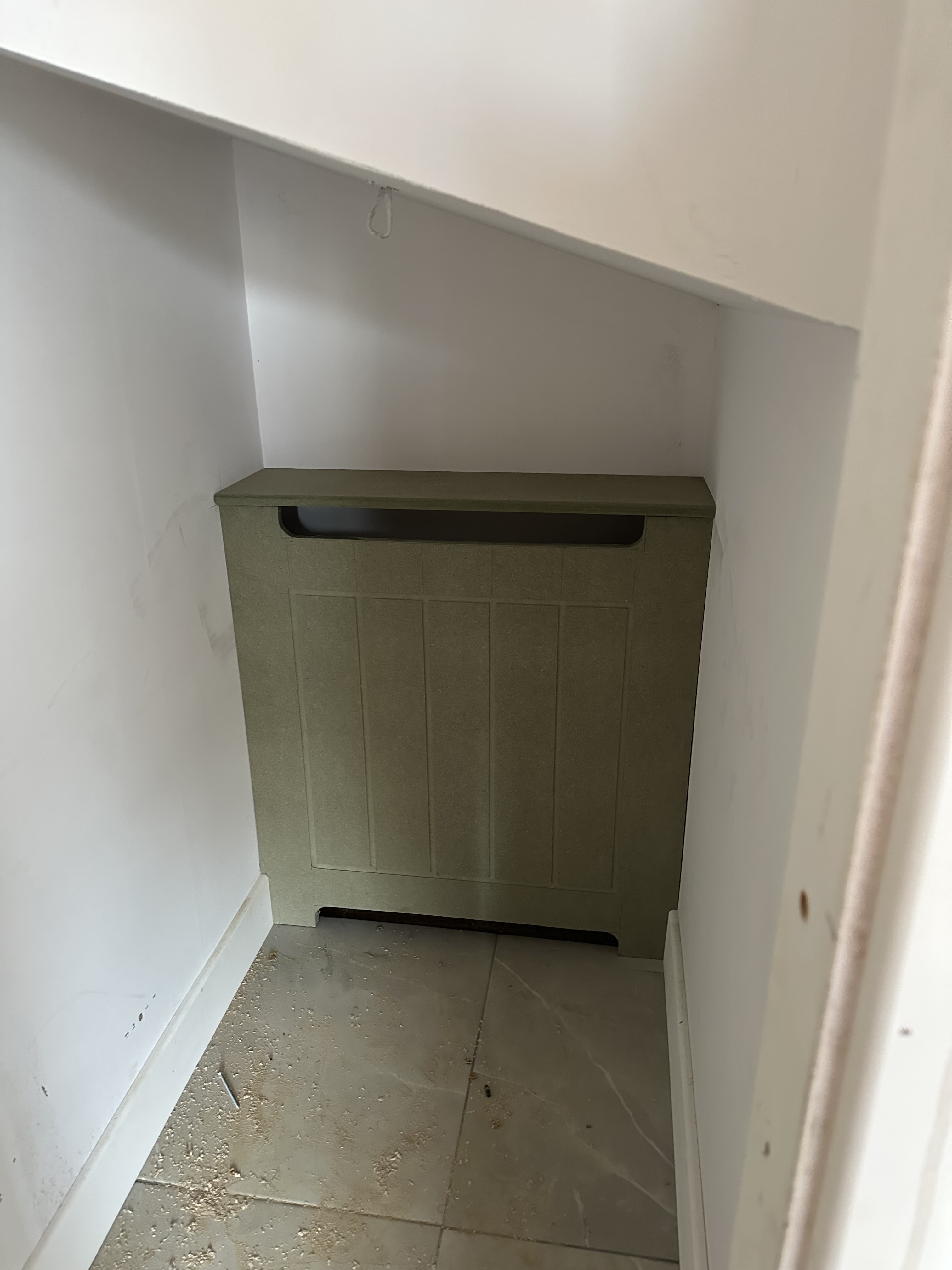 Under stair fitted storage in sage green